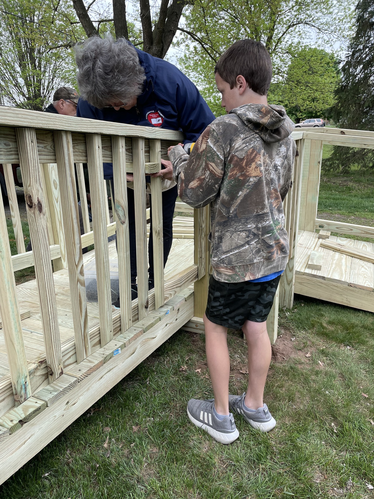 boy helping a women screw in spindles